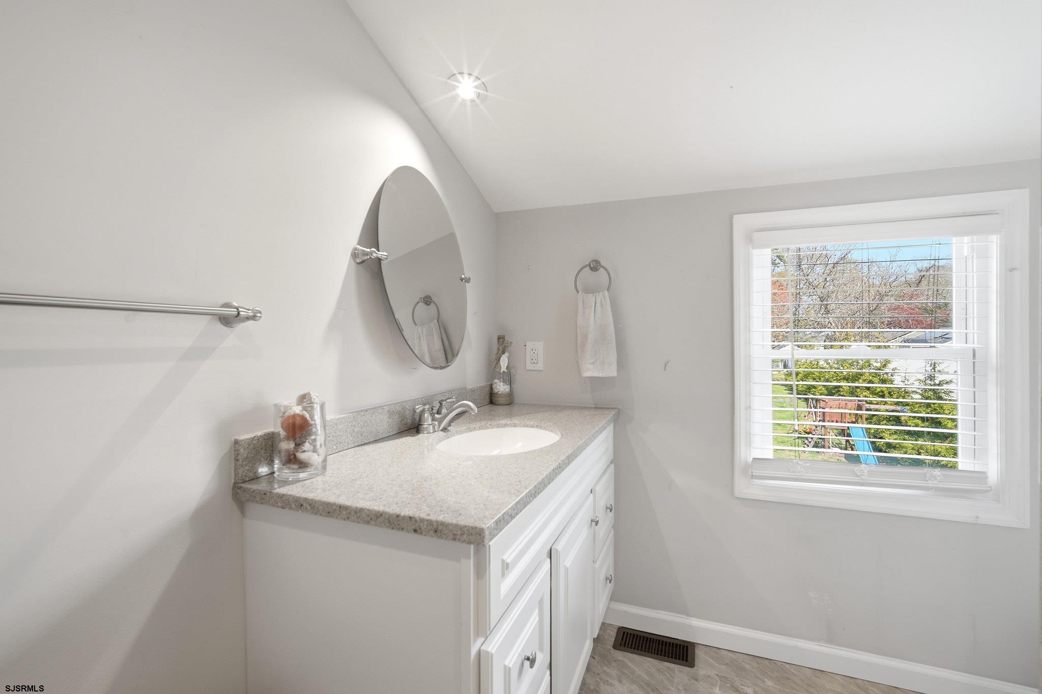 395 1st Street Northfield, NJ 08225 - Photo 25 of 54 a bathroom with a granite countertop sink a mirror and a shower