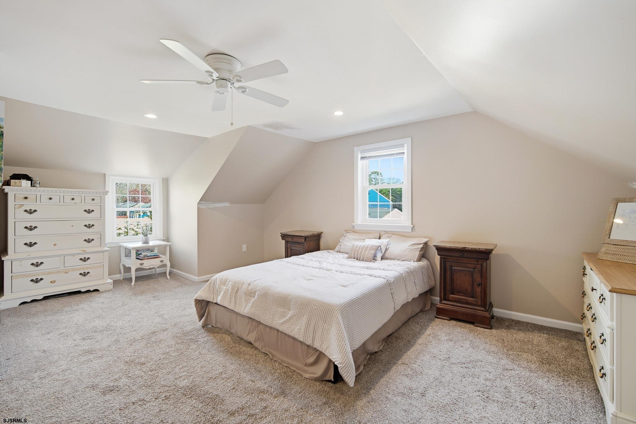 395 1st Street Northfield, NJ 08225 - Photo 26 of 54 a bedroom with a bed a dresser and a window