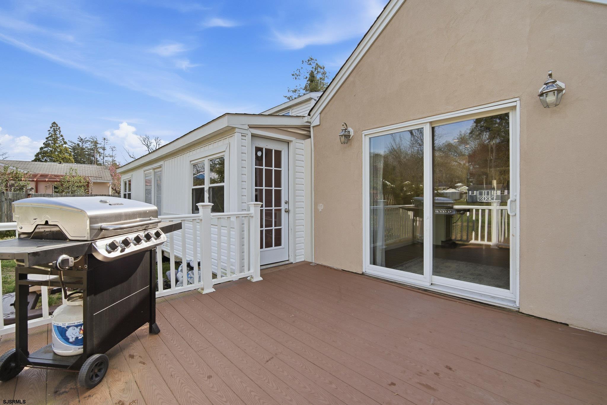 395 1st Street Northfield, NJ 08225 - Photo 29 of 54 a view of a house with a barbeque grill and floor to ceiling window