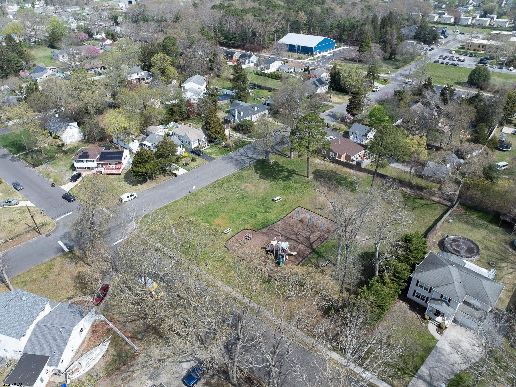 395 1st Street Northfield, NJ 08225 - Photo 52 of 54 an aerial view of a house with a yard and lake view