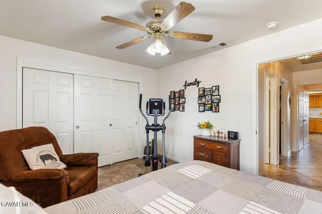 a bedroom with furniture and wooden floor