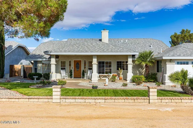 a front view of a house with garden and porch area