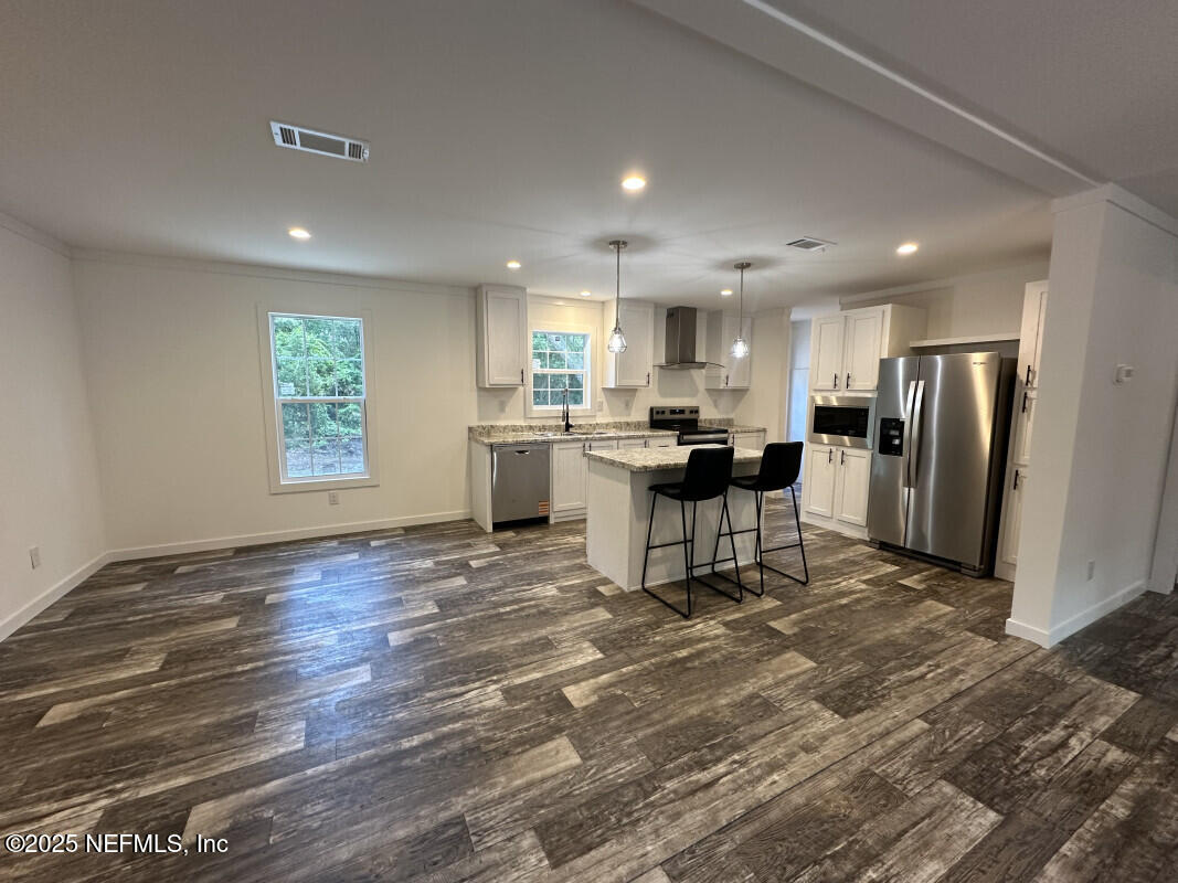 138 Nichols Road Florahome, FL 32140 - Photo 11 of 27 a view of a kitchen with a sink and a refrigerator
