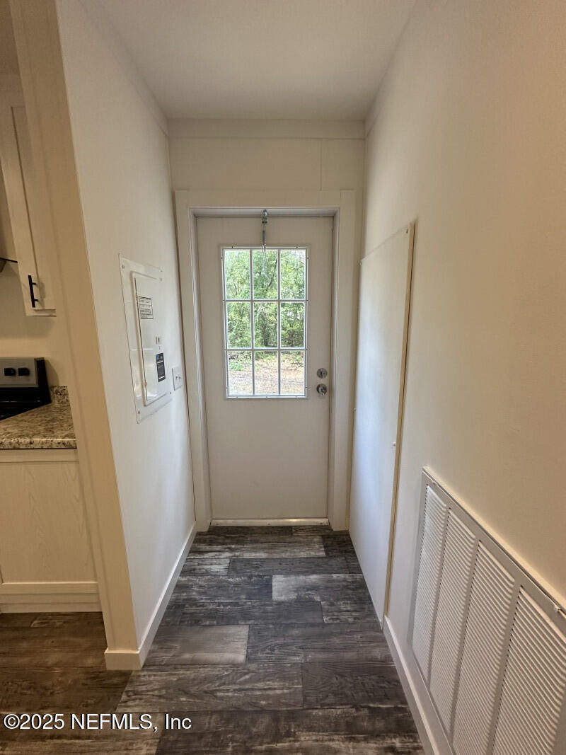 138 Nichols Road Florahome, FL 32140 - Photo 17 of 27 a view of a hallway with wooden floor and a living room