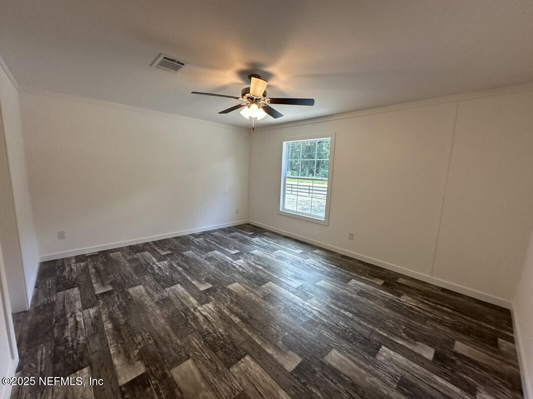 138 Nichols Road Florahome, FL 32140 - Photo 19 of 27 wooden floor in an empty room with a window