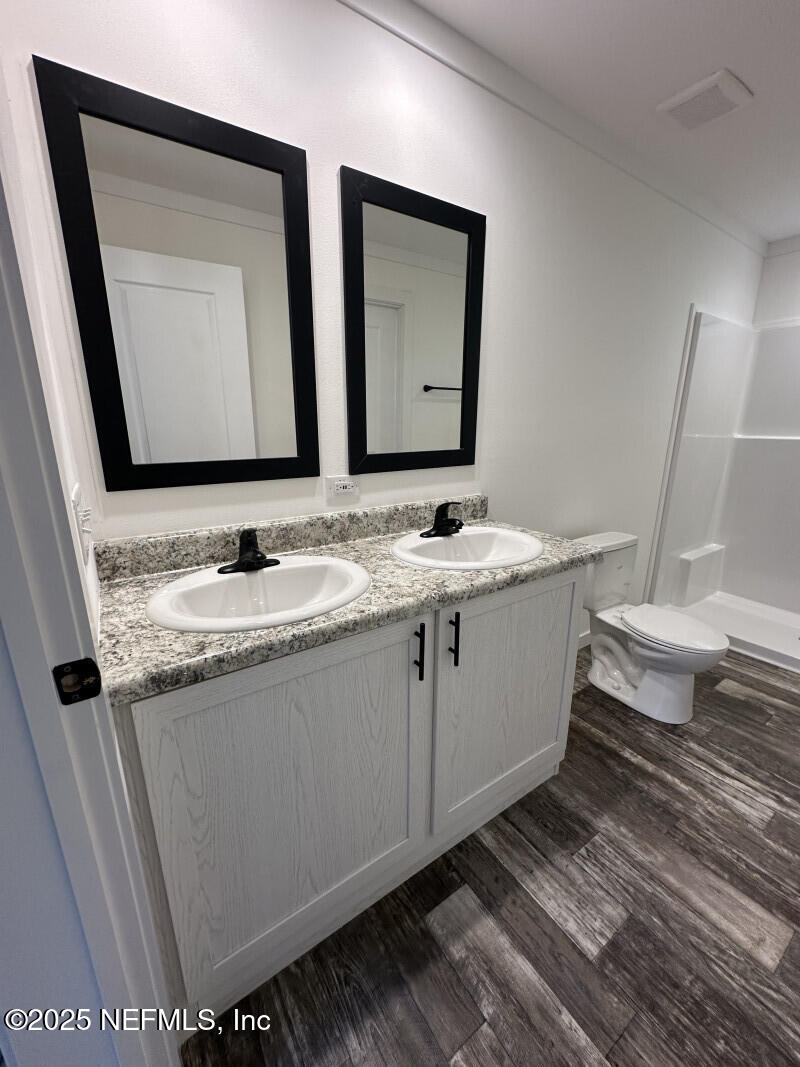 138 Nichols Road Florahome, FL 32140 - Photo 21 of 27 a bathroom with a granite countertop sink and a mirror
