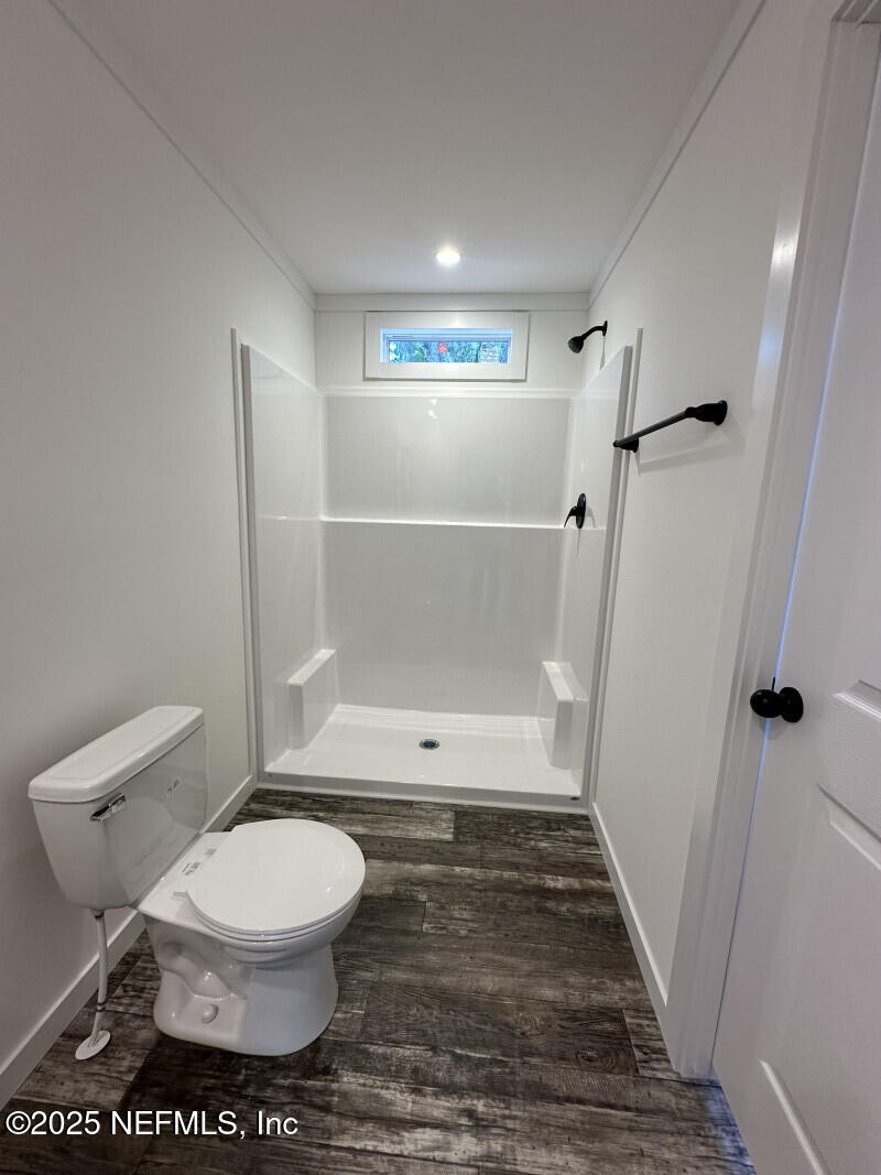 138 Nichols Road Florahome, FL 32140 - Photo 22 of 27 a bathroom with a toilet and a shower