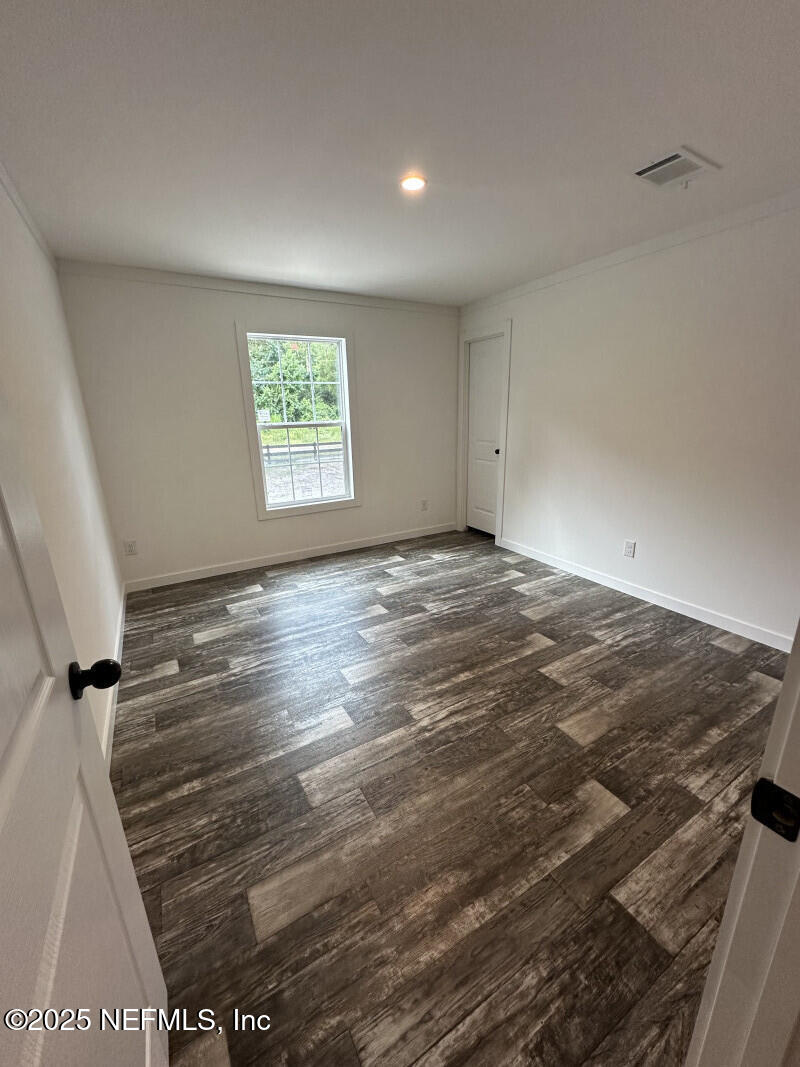 138 Nichols Road Florahome, FL 32140 - Photo 23 of 27 a view of room with window and hardwood floor