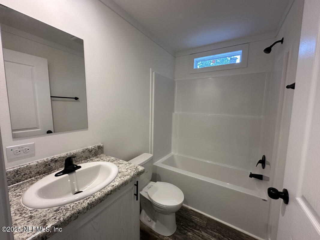 138 Nichols Road Florahome, FL 32140 - Photo 27 of 27 a bathroom with a granite countertop sink toilet and shower