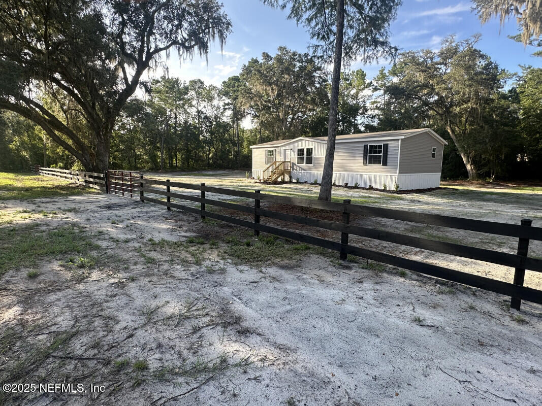 138 Nichols Road Florahome, FL 32140 - Photo 3 of 27 a front view of a house with garden