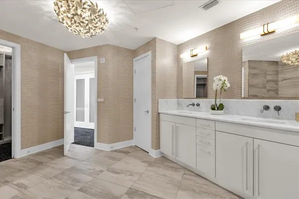a bathroom with a tub a sink shower and mirror