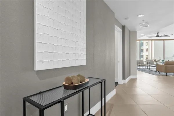 a living room with furniture kitchen view and a large window