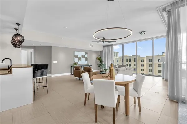 a view of a dining room with furniture and a chandelier