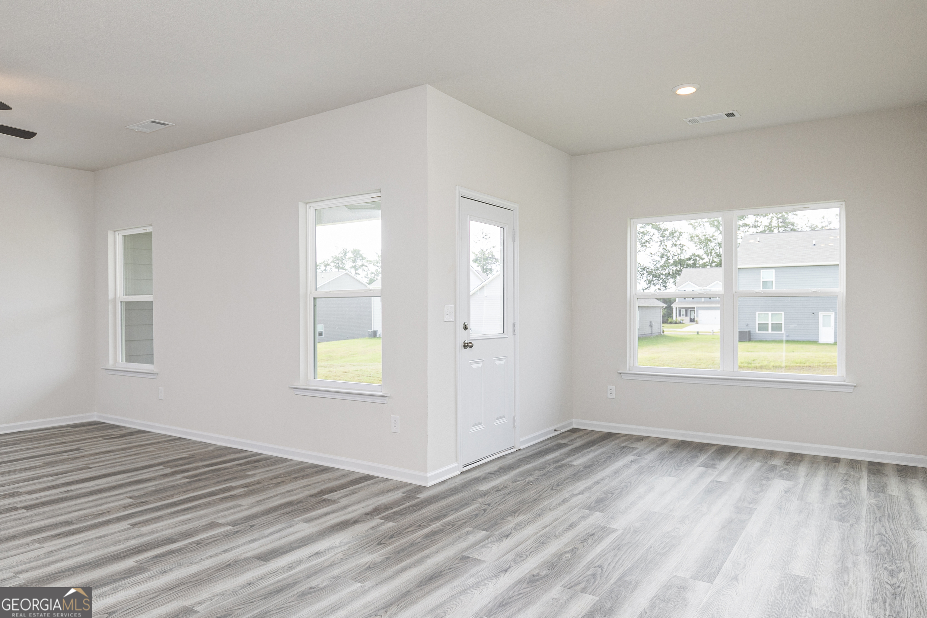 632 Slate Road Conyers, GA 30013 - Photo 6 of 26 a view of an empty room with wooden floor and a window