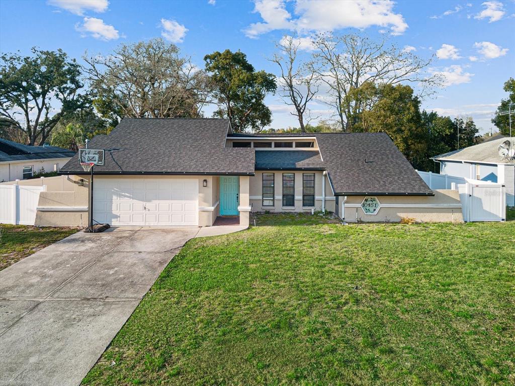 10451 Dunkirk Road Spring Hill, FL 34608 - Photo 1 of 1 front view of a house with a yard