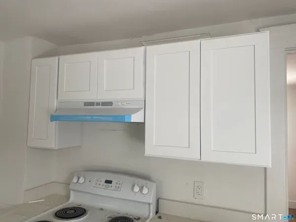 a view of kitchen with white cabinets