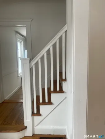 a view of staircase with white walls and a window