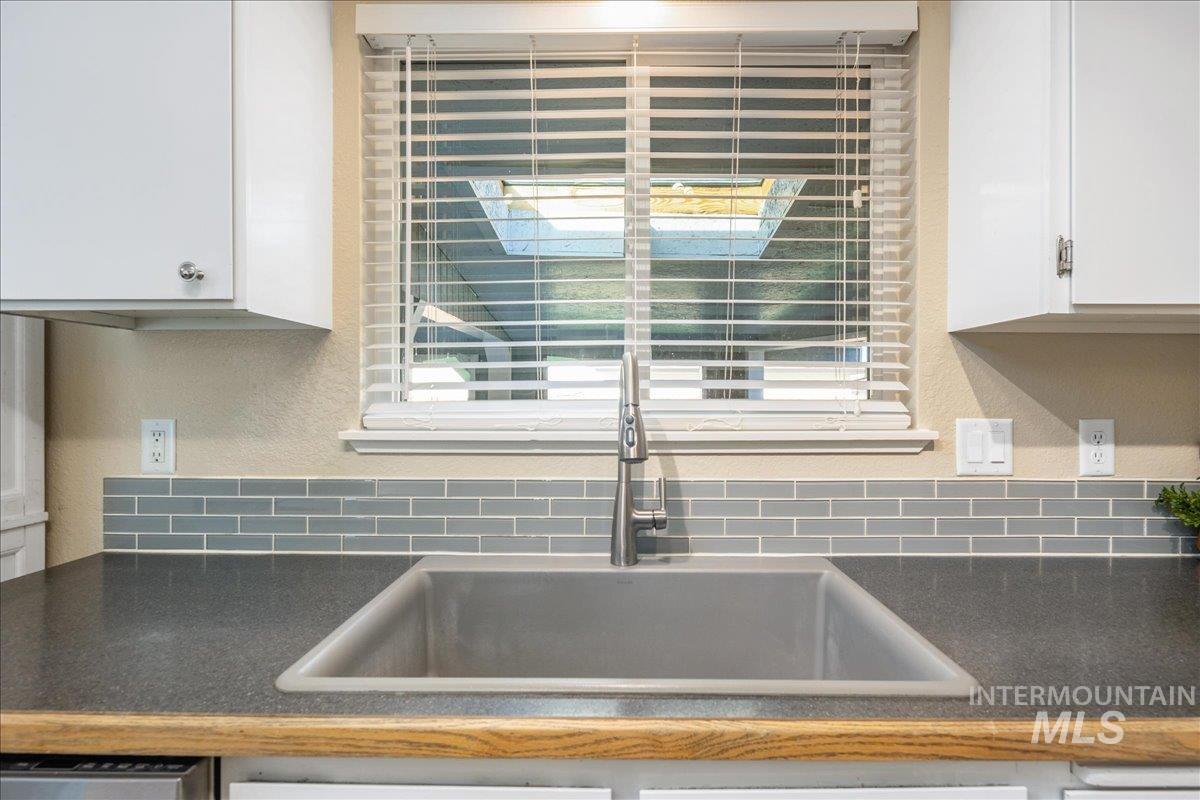 2103 North Hampton Road Boise, ID 83704 - Photo 15 of 40 Kitchen with dark countertops, white cabinets, and a textured wall