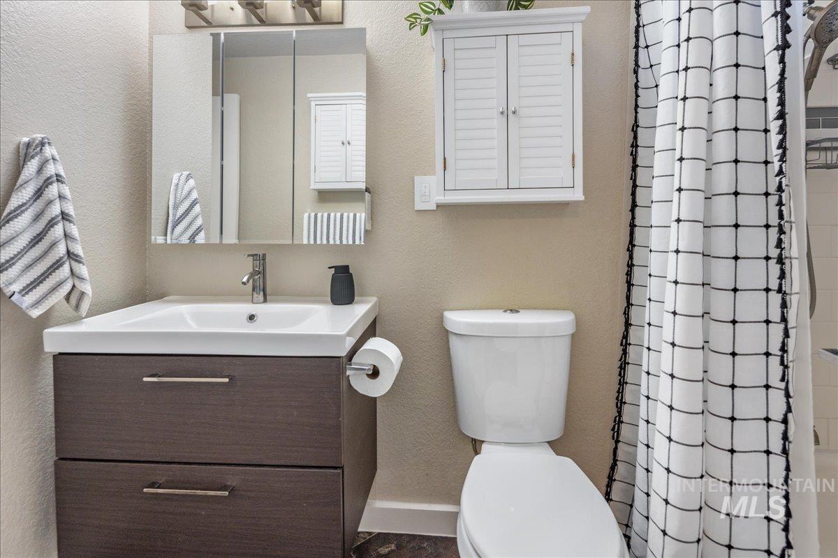2103 North Hampton Road Boise, ID 83704 - Photo 18 of 40 Full bath with a textured wall, vanity, and a shower with shower curtain