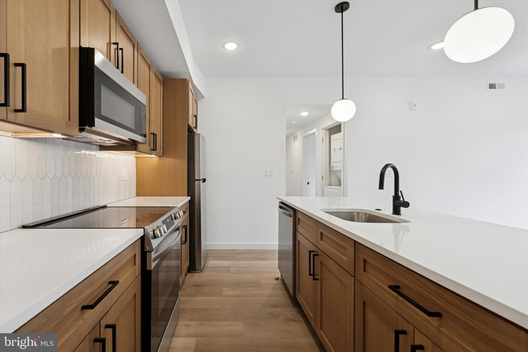 754 South 4th Street, Unit 201 Philadelphia, PA 19147 - Photo 3 of 17 a kitchen with a sink and a stove top oven