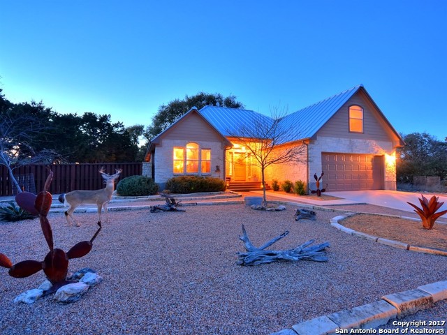 10 Longbow Lane Wimberley, TX 78676 - Photo 1 of 1 a view of a backyard with a slide and table in the patio