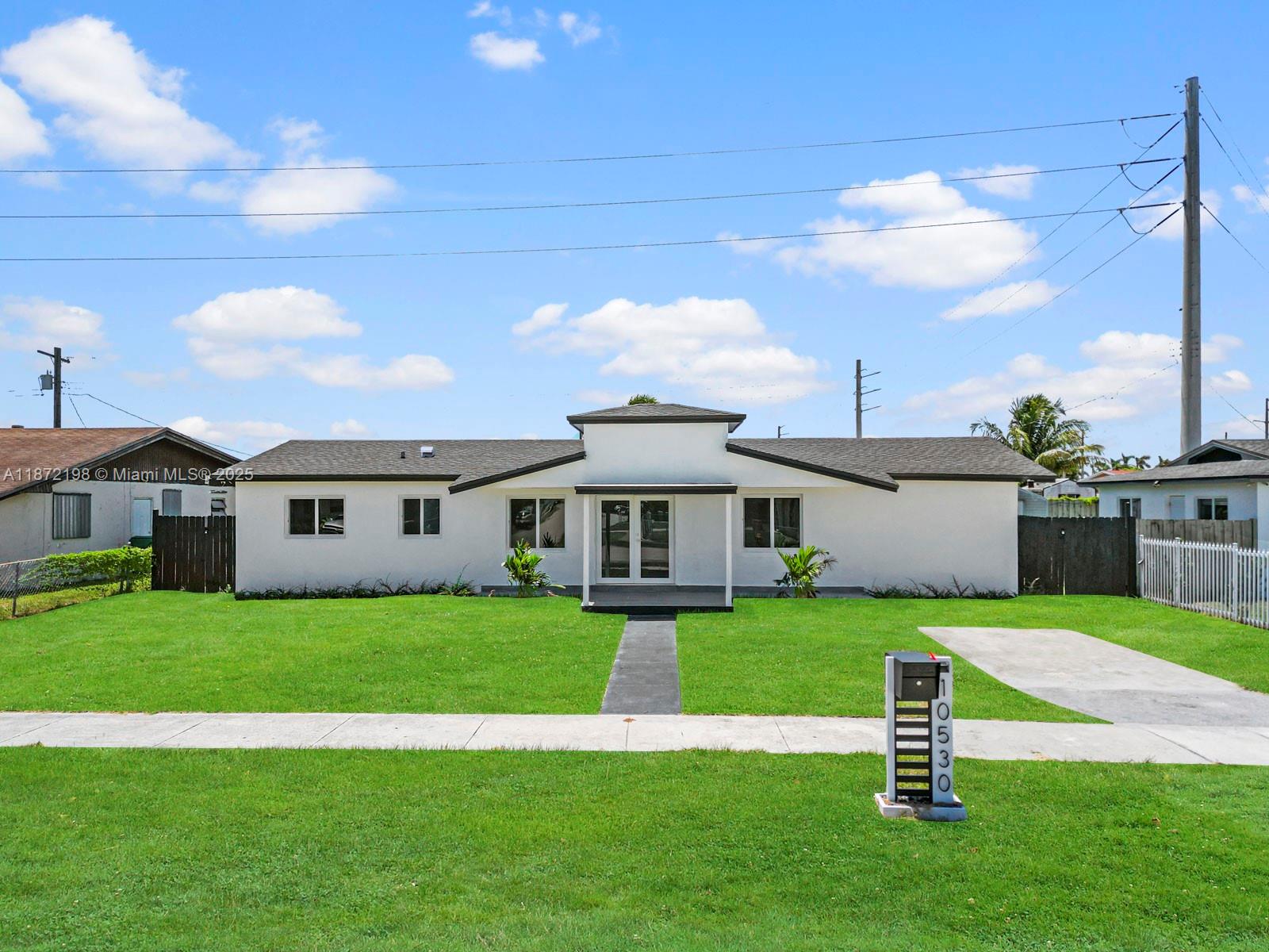 10530 Southwest 146th Street Miami, FL 33176 - Photo 1 of 54 a view of a house with a yard and sitting area