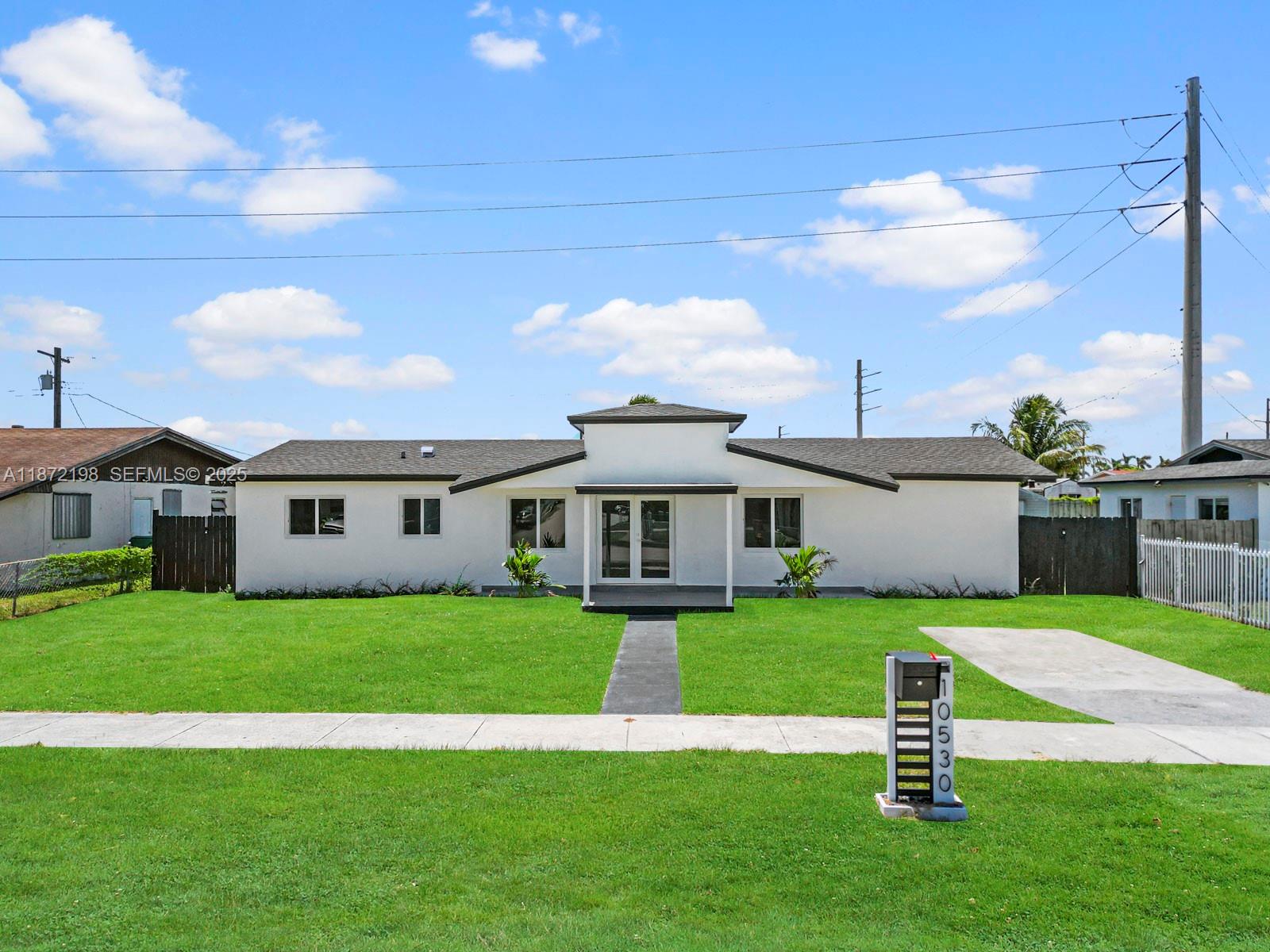 a view of a house with a yard and sitting area