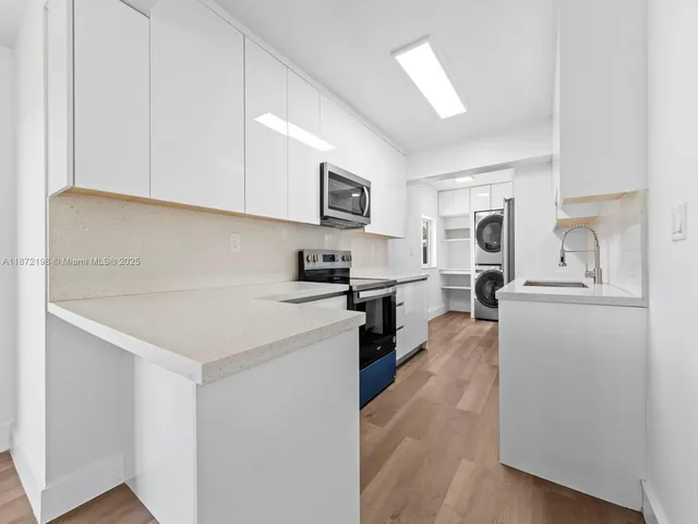 a kitchen with stainless steel appliances a refrigerator sink and stove