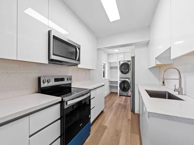 a kitchen with stainless steel appliances a stove sink and cabinets