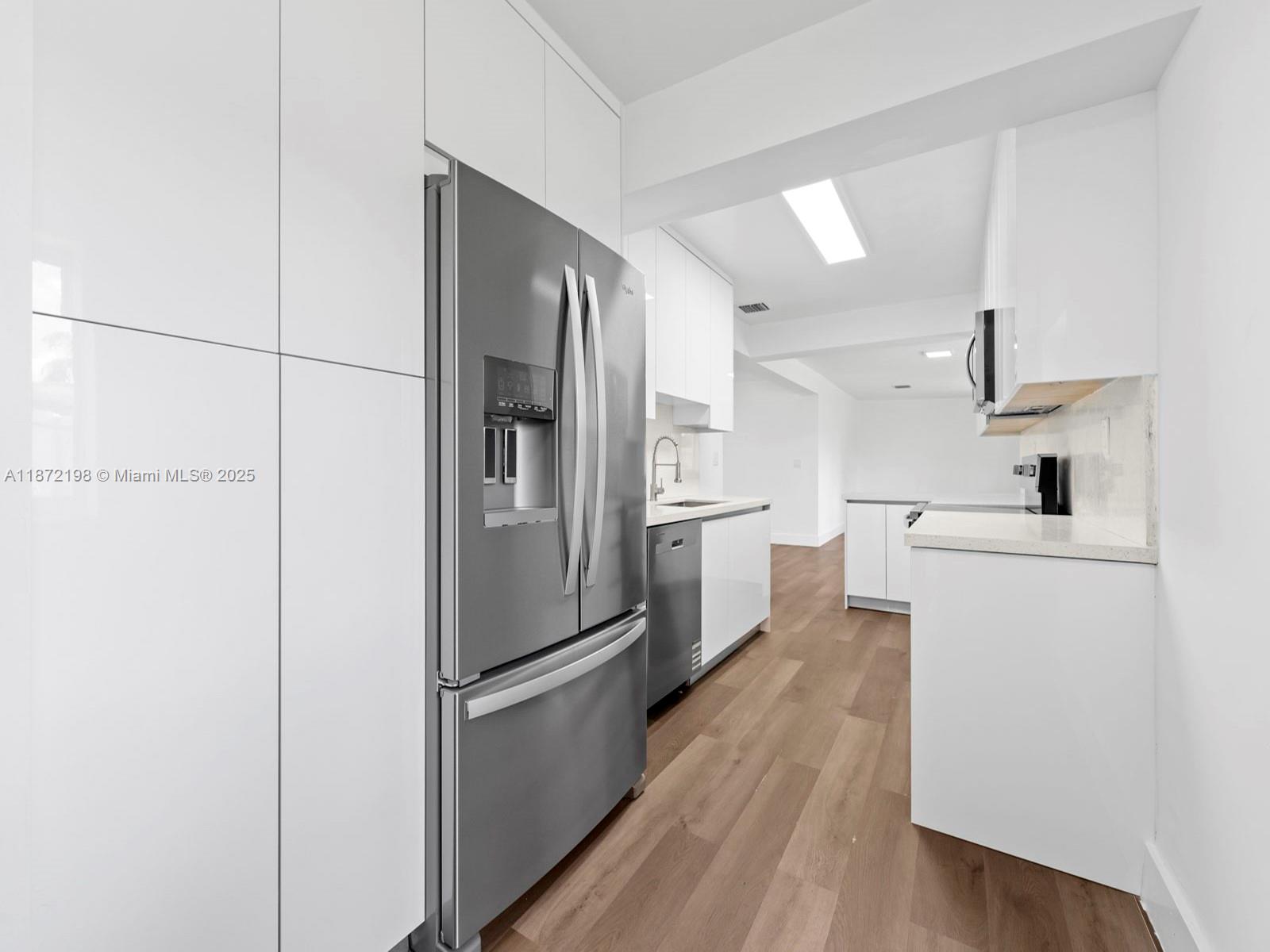 10530 Southwest 146th Street Miami, FL 33176 - Photo 14 of 54 a kitchen with a refrigerator a sink and dishwasher