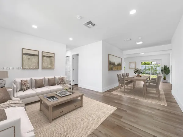 a living room with furniture and wooden floor
