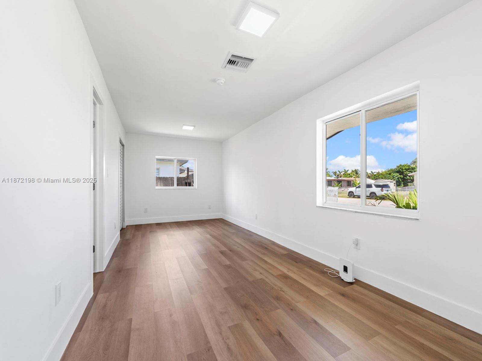 10530 Southwest 146th Street Miami, FL 33176 - Photo 23 of 54 wooden floor in an empty room with a window