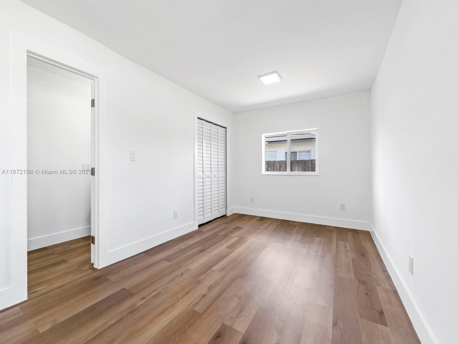 10530 Southwest 146th Street Miami, FL 33176 - Photo 24 of 54 an empty room with wooden floor and windows