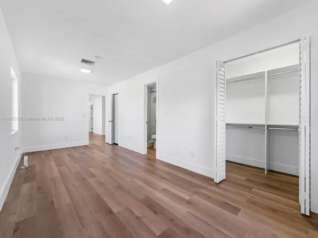 a hallway view with staircase