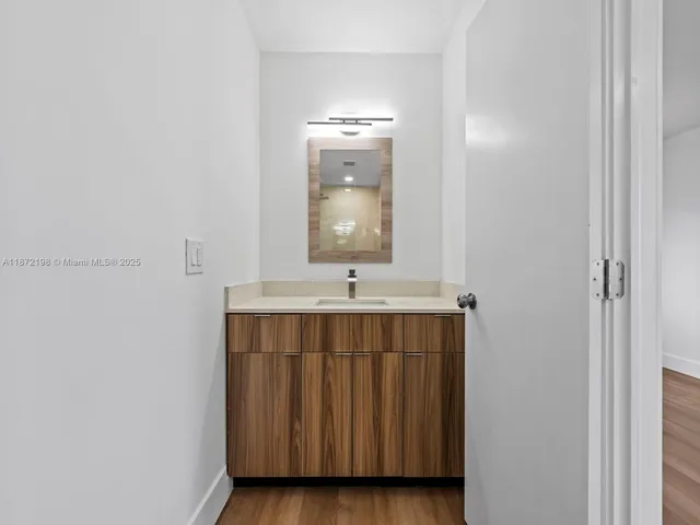 a white toilet sitting next to a bathroom sink