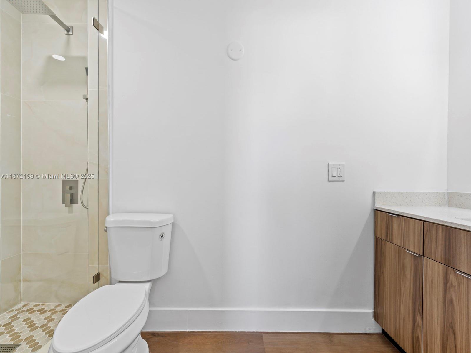 10530 Southwest 146th Street Miami, FL 33176 - Photo 30 of 54 a white toilet sitting next to a bathroom sink