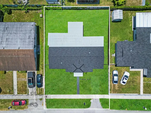an aerial view of house with a garden