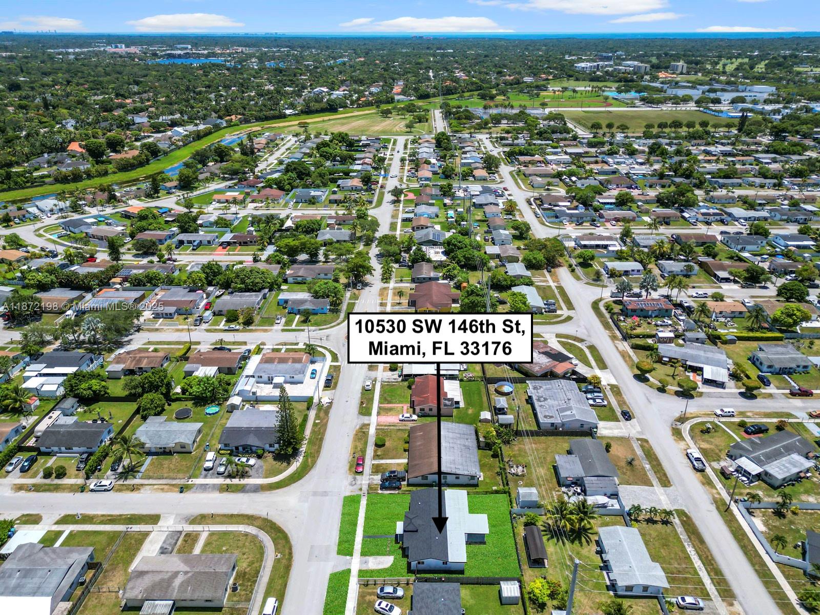 10530 Southwest 146th Street Miami, FL 33176 - Photo 35 of 54 an aerial view of houses with a city street