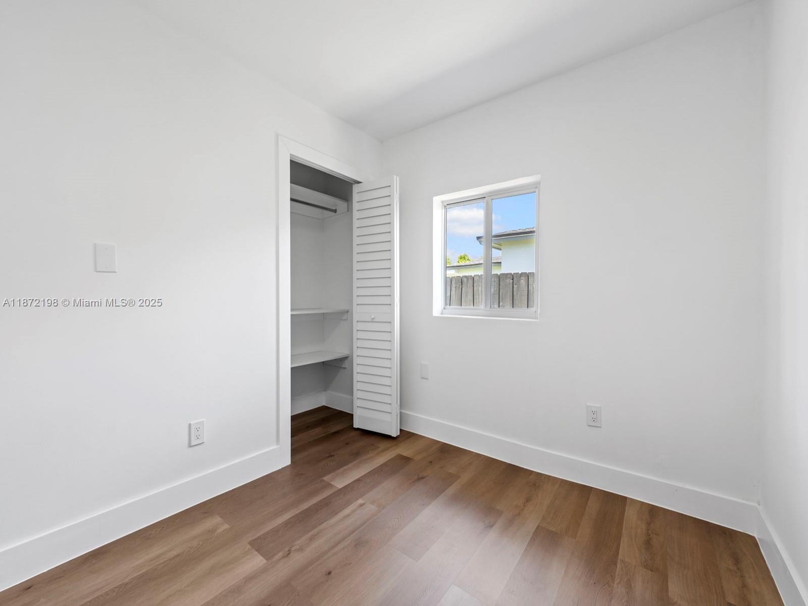 10530 Southwest 146th Street Miami, FL 33176 - Photo 37 of 54 an empty room with wooden floor and windows