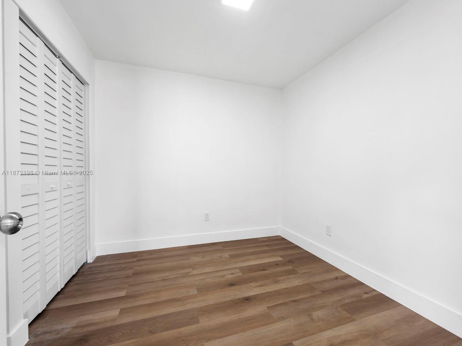 10530 Southwest 146th Street Miami, FL 33176 - Photo 39 of 54 a view of an empty room with wooden floor and a window