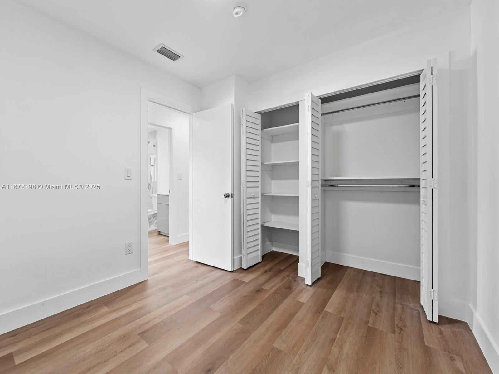 10530 Southwest 146th Street Miami, FL 33176 - Photo 40 of 54 a view of empty room with wooden floor