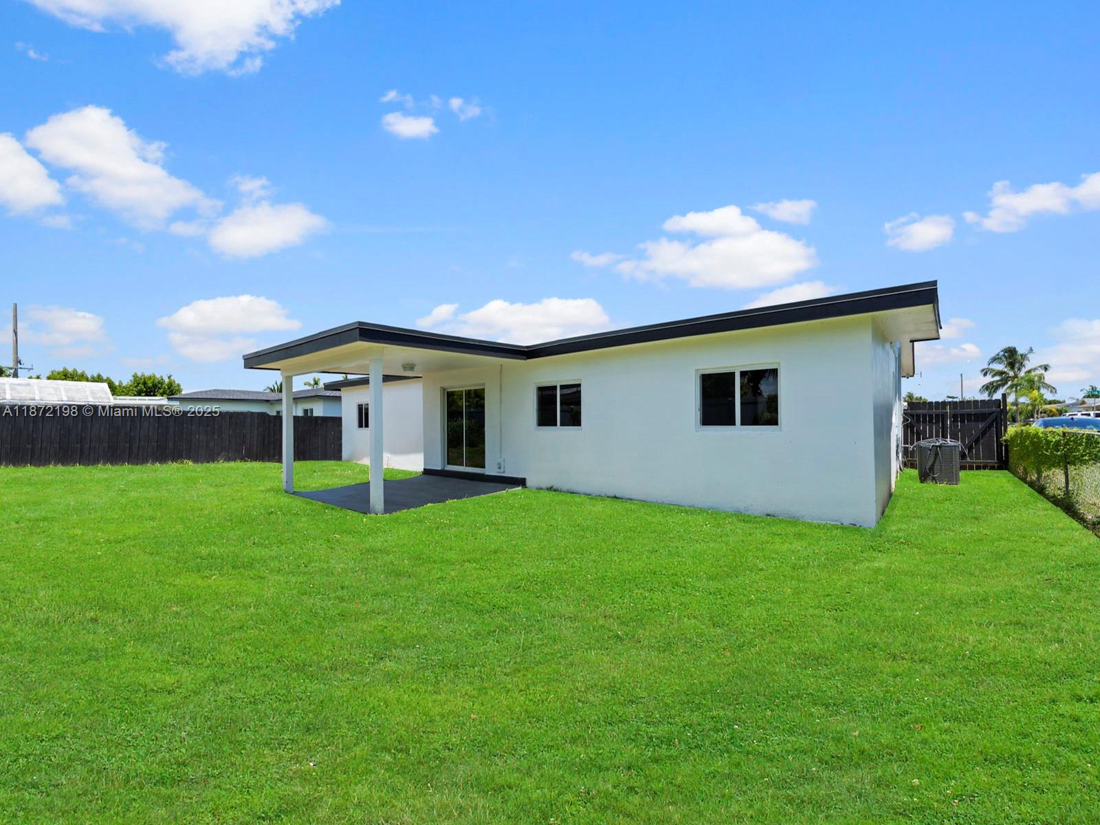 10530 Southwest 146th Street Miami, FL 33176 - Photo 49 of 54 a view of a house with a backyard
