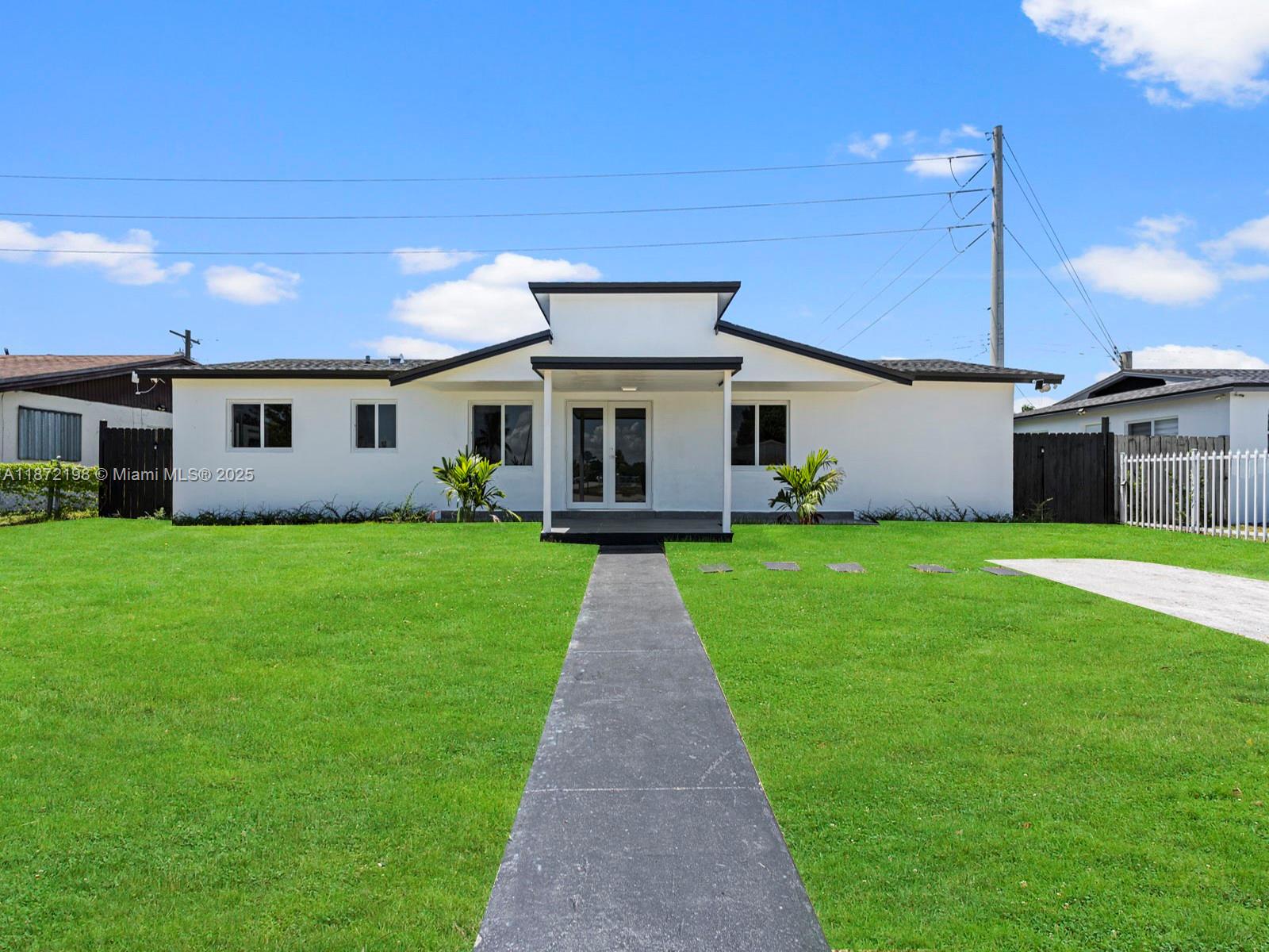 10530 Southwest 146th Street Miami, FL 33176 - Photo 51 of 54 a front view of house with yard