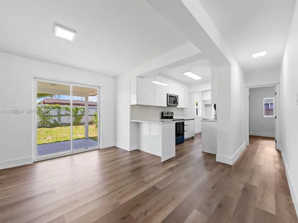 a view of kitchen with furniture and wooden floor