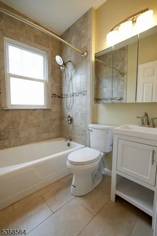a bathroom with a toilet a sink and bathtub