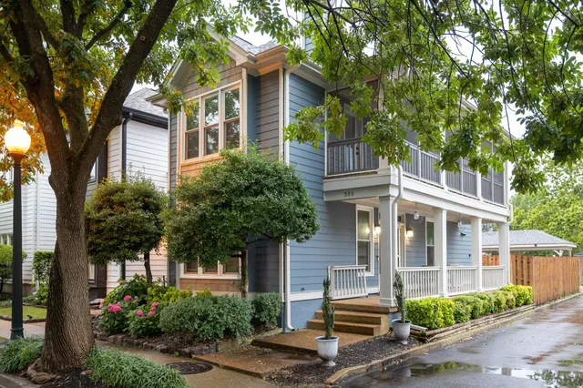 front view of a house with a tree