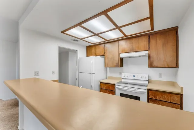 a kitchen with stainless steel appliances a refrigerator and a stove