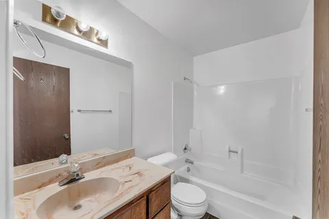 a bathroom with a sink toilet tub and shower