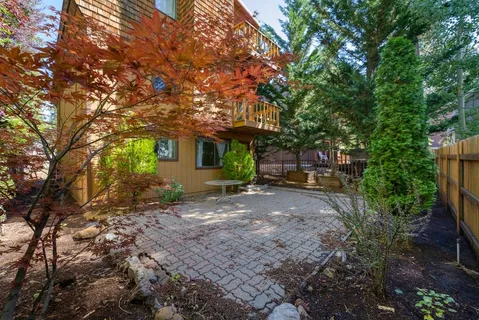 a view of a patio with furniture and garden