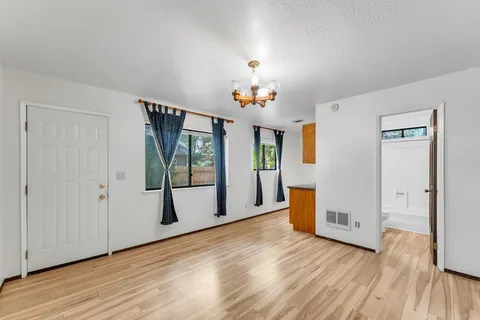 a view of an empty room with glass door